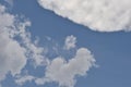 Deep blue sky background with white puffy & fluffy cumulus or cumulonimbus cloud