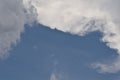 Deep blue sky background with white puffy & fluffy cumulus or cumulonimbus cloud in tropical summer climate weather