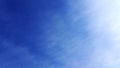 Deep blue sky sunlight shot with plane and blending clouds. Royalty Free Stock Photo