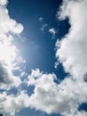 Deep blue sky and sun shining through the clouds. Royalty Free Stock Photo