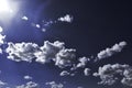 Deep Blue Sky and White Clouds with Sunburst and Flare Royalty Free Stock Photo