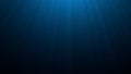 Deep blue undersea with sunlight ray through over surface ripple wave background. Dark scene beneath blue sun beam. Abstract Royalty Free Stock Photo