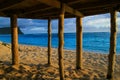 Deep blue waters of Pacific Ocean view through wooden pillars of beach fale - traditional Samoan house Lalomanu beach Samoa