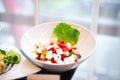 Deep bowl Greek salad of tomatoes, peppers, cucumbers, feta, shallots and olives