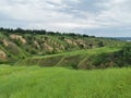 A deep clay ravine formed by erosion by a water stream. Soil erosion