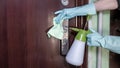 Deep cleaning for the prevention of viral diseases. Disinfection a door handle at home with an alcohol disinfectant spray Royalty Free Stock Photo