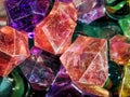 Deep-colored marble-like stones and colorful glass orbs, close-up background with selective focus