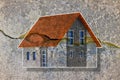 Deep crack in old brick wall with damaged plaster and colored house model - concept image Royalty Free Stock Photo