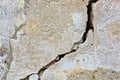 Deep and dangerous crack in an old brick wall with damaged plaster Royalty Free Stock Photo