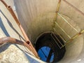 Deep dark well top closeup view of concrete rings to the bottom