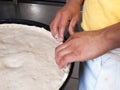 Deep Dish pizza being assembled