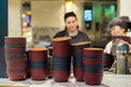 Deep dishes stacked in piles on a kitchen counter in a fast food restaurant. Cooks on a blurred background