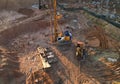 Deep foundation machine. Drilling rig and Pile driver at construction site. Pile driven into ground by vibrating hydraulic hammer Royalty Free Stock Photo