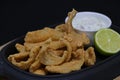 Deep fried anchovies with tartar sauce and lime wedge in a serving dish Royalty Free Stock Photo