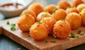Deep fried arancini balls on wooden board - traditional Italian cuisine. Stuffed rice balls