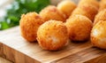 Deep fried arancini balls on wooden board - traditional Italian cuisine. Stuffed rice balls