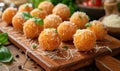 Deep fried arancini balls on wooden board - traditional Italian cuisine. Stuffed rice balls