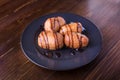 Deep fried bananas on plate over wooden table background. Tasty dessert from pan fried bananas in asian style Royalty Free Stock Photo