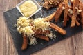 Deep Fried black rye bread with cheese salt and spices, on a plate