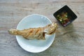 Deep fried blacktip grouper fish dipping chili and garlic sauce on plate Royalty Free Stock Photo