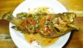 Deep fried blacktip grouper fish dressing sweet chili sauce on plate Royalty Free Stock Photo