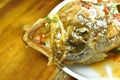 Deep fried blacktip grouper fish dressing sweet chili sauce on plate Royalty Free Stock Photo