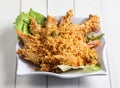 Deep fried cereal prawn served in dish isolated on table top view of singapore food