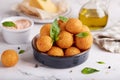 Deep fried Cheese balls. Freshly baked croquettes, served with basil leafs and sauce. Royalty Free Stock Photo