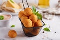 Deep fried Cheese balls. Freshly baked croquettes, served with basil leafs and sauce. Royalty Free Stock Photo