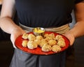 Deep fried cheese balls with sauce served by waiter in a plate. Waiter at work, restaurant service.