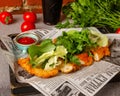 Makhachkala, Dagestan, RUS, May 17, 2019 Sliced fried chicken breast garnished with chopped herbs, lettuce and spinach on a Royalty Free Stock Photo