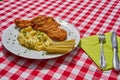 Deep fried chicken escalope or schnitzel with mashed potatoes and pickled cucumbers.