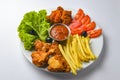 Deep fried chicken platter, chicken wings, nuggets, french fries and fresh green salad with dip tomato sauce Royalty Free Stock Photo