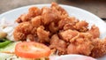 Deep fried chicken tendons on white dish close up with wooden ba Royalty Free Stock Photo