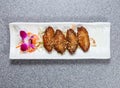 deep fried chicken wings with lemongrass served in dish isolated on grey background top view of hong kong food Royalty Free Stock Photo