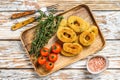 Deep fried crispy onion rings breaded. White wooden background. Top view