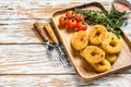 Deep fried crispy onion rings breaded. White wooden background. Top view. Copy space