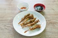 Deep fried duck beak with white sesame dipping chili and black sweet soy sauce on plate