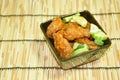 Deep fried fish patty dressing slice cucumber in sweet chili sauce on bowl Royalty Free Stock Photo