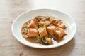 Deep fried fish tofu with chop pork topping slice mushroom in sweet and sour gravy sauce on plate Royalty Free Stock Photo