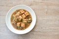 Deep fried fish tofu with chop pork topping slice mushroom in sweet and sour gravy sauce on plate Royalty Free Stock Photo