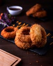 Deep Fried Golden Crispy Onion Rings with dip served in dish isolated on wooden table side view of arabic food Royalty Free Stock Photo