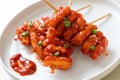 Deep fried Korean rice cake Tteokbokki skewered with spicy sauce