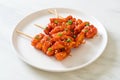 Deep fried Korean rice cake Tteokbokki skewered with spicy sauce