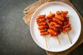 Deep fried Korean rice cake Tteokbokki skewered with spicy sauce