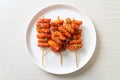 Deep fried Korean rice cake Tteokbokki skewered with spicy sauce Royalty Free Stock Photo