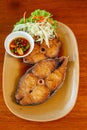 Deep Fried Mackerel with Fish Sauce on plate with wooden table background Royalty Free Stock Photo