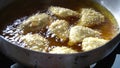 Deep fried Malaysia traditional chicken curry puff in the hot boiling oil.