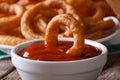 Deep-fried onion rings with ketchup macro. horizontal, rustic Royalty Free Stock Photo