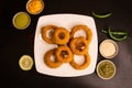 Deep fried Onion Rings with lime, dip and sauce served in a dish isolated on table top view of fastfood Royalty Free Stock Photo